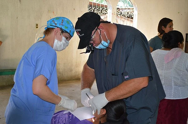 Dr. Bradley Dyer is giving a checkup to a patient on their Guatemala mission trip
