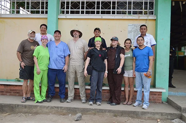 Group of missionaries and Dr. Dyer outside the clinic they were volunteering at